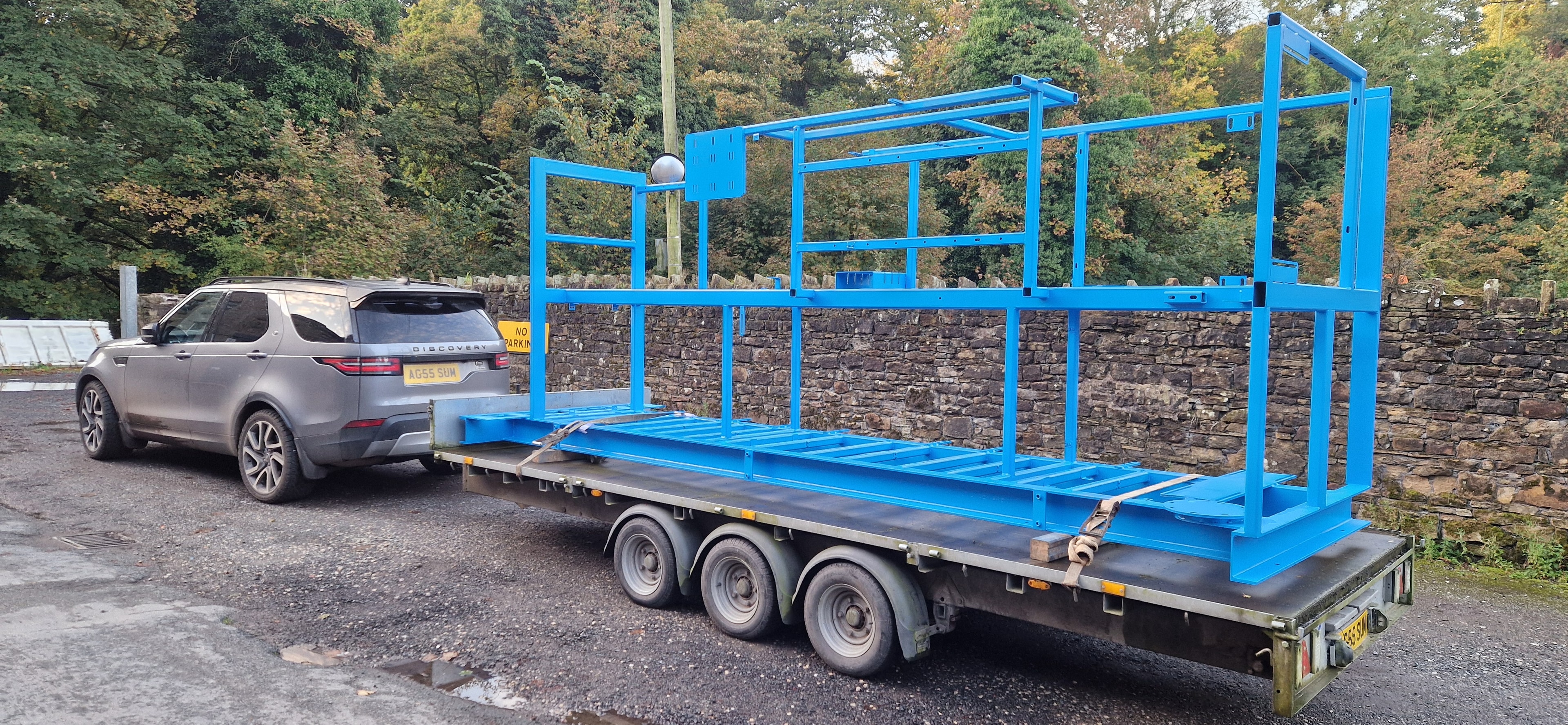Blue painted steel frame structure on trailer