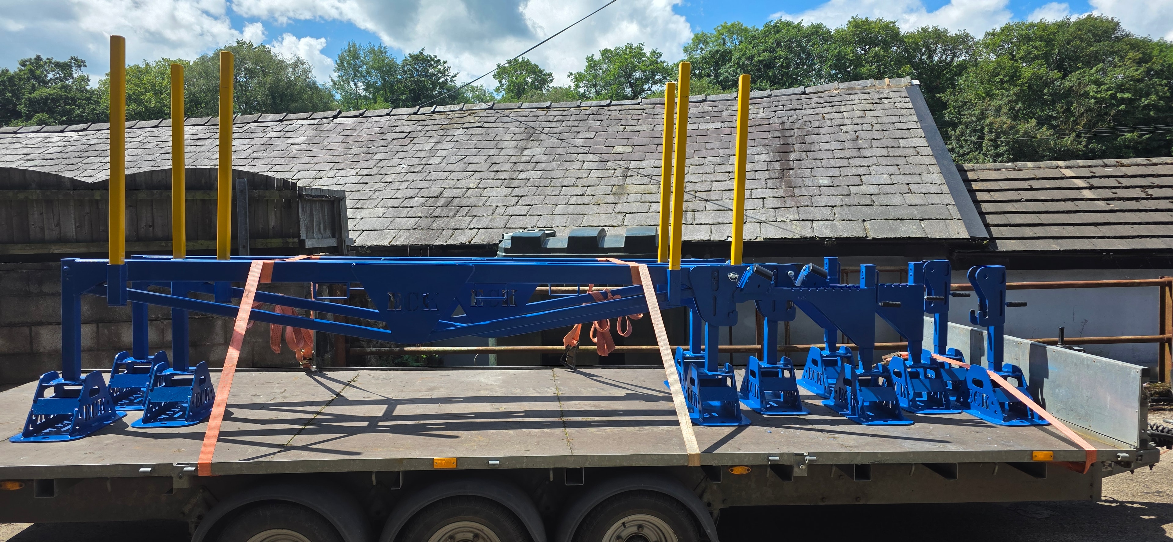Blue painted steel framework on flatbed trailer